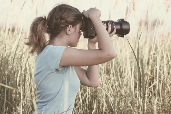 Vintage portrait of a young girl photographer working in the field of professional photographic equipment