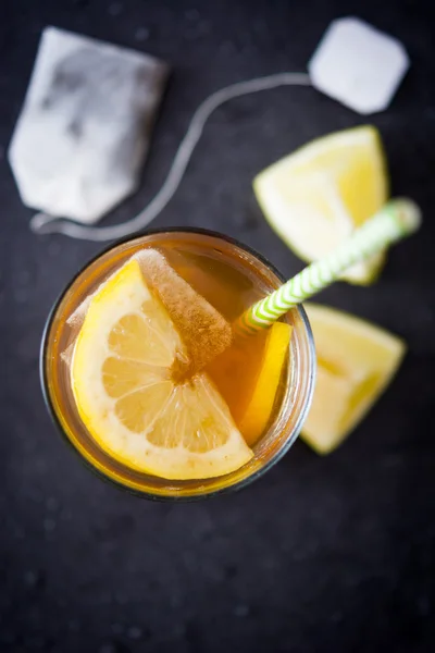 Ice tea with lemon. Black stone