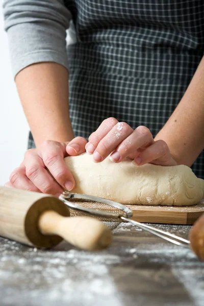 Woman kneading bread dough