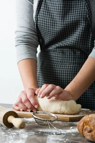 Woman kneading bread dough