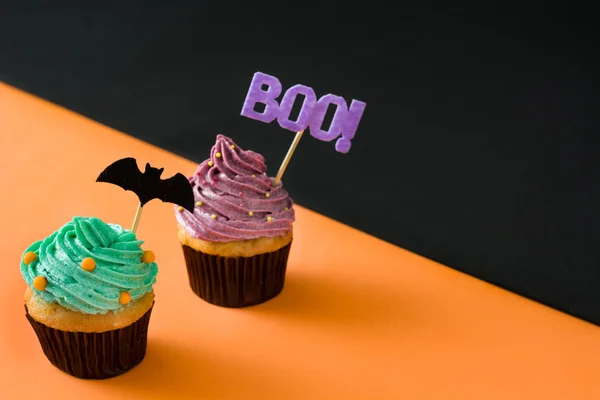 Halloween cupcakes on black and orange background