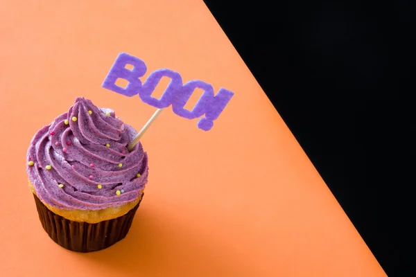 Halloween cupcake on black and orange background