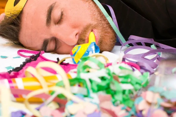 Young man sleeping after a party