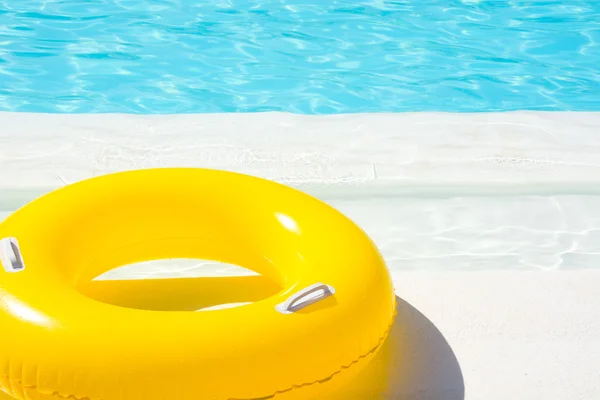 Yellow pool float in blue swimming pool