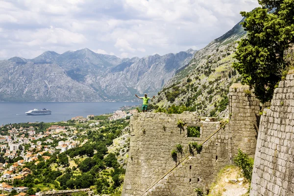 The traveler stands on the ramparts in the old town of Kotor