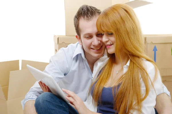 Couple arranging new apartment with digital tablet