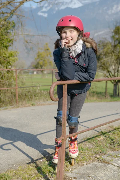 Preteen with roller skate helmet, eat a cake