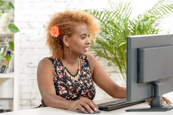 A young black secretary working with a computer