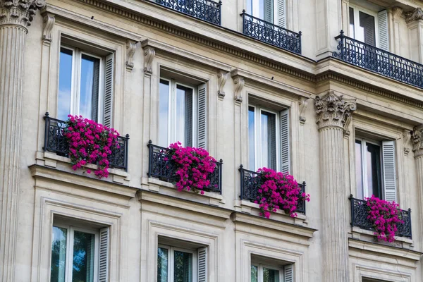 Old residential building front with flowers, Paris.
