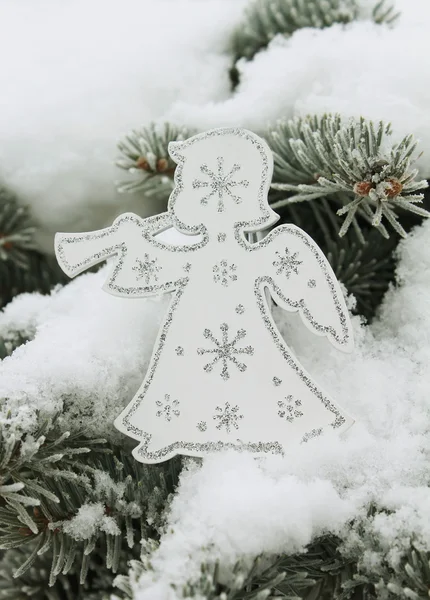 Christmas white angel with silvery snowflakes on christmas tree