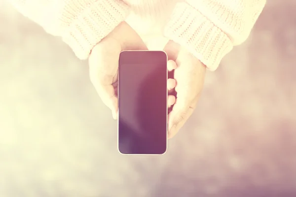 Woman hands with blank black cell phone screen, mock up