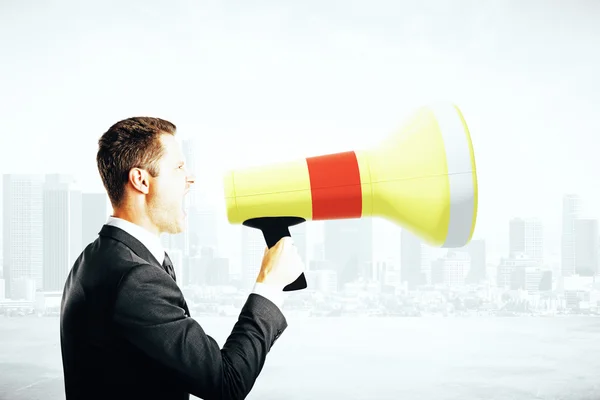 Businessperson screaming into megaphone