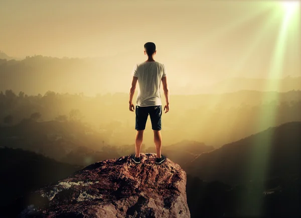 Man stands on top of mountain