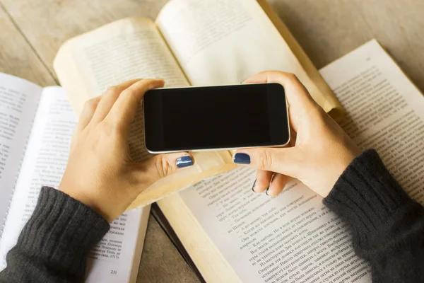 Girl with cell phone and books