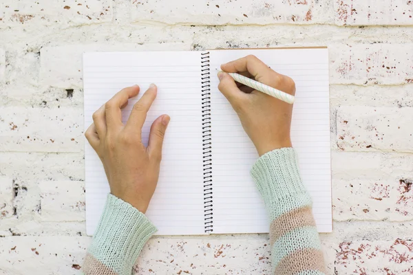 Girl writes in notebook