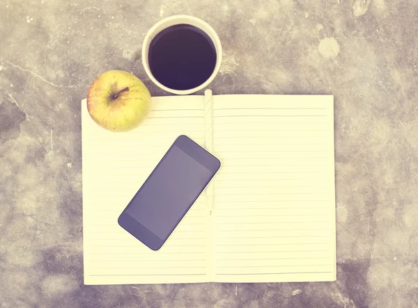 Coffee, cell phone, apple and blank diary with a pencil, vintage