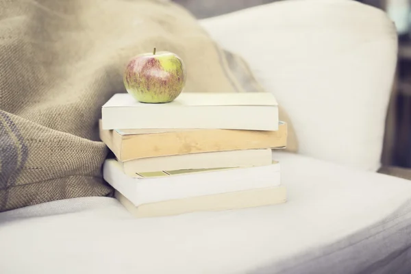 Pack of books and apple