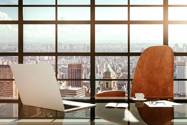 Modern workplace with a laptop and office accessories at sunrise