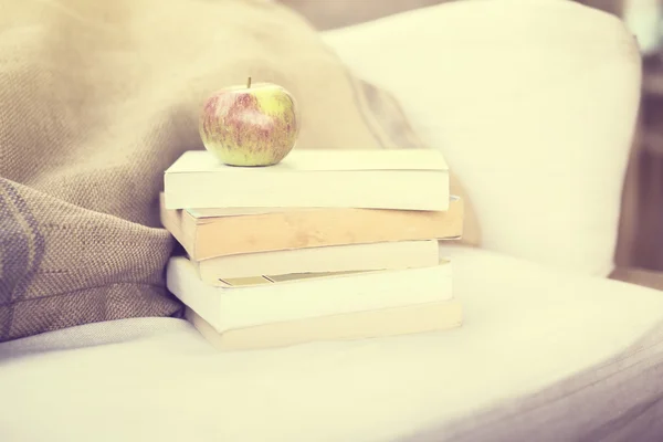 Pack of books and apple