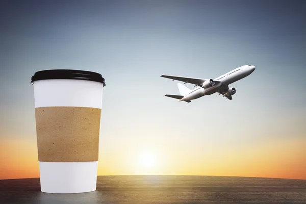 Cup of coffee and plane flying away