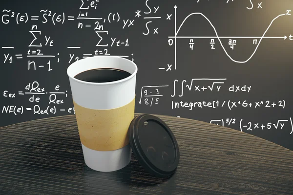 White cup of coffee on dark brown table with equation background