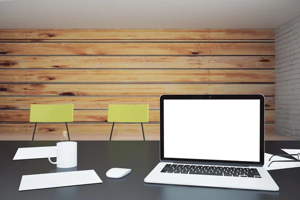 Blank white laptop screen on black table in loft office, mock up