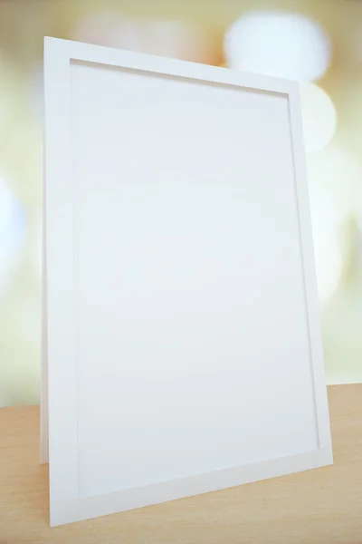 Blank white picture frame on the table, mock up