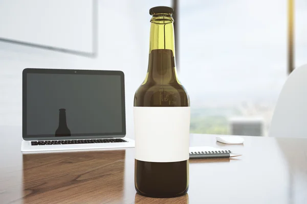 Blank beer bottle on the wooden table, mock up