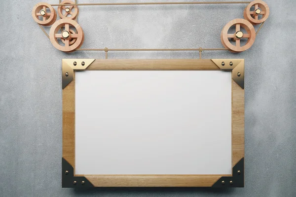 Blank picture frame in the style of steampunk hanging on concret