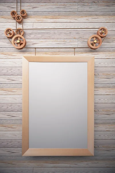 Blank picture frame in the style of steampunk hanging on wooden