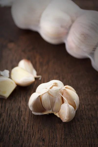 Garlic bulbs with garlic cloves on a wooden table