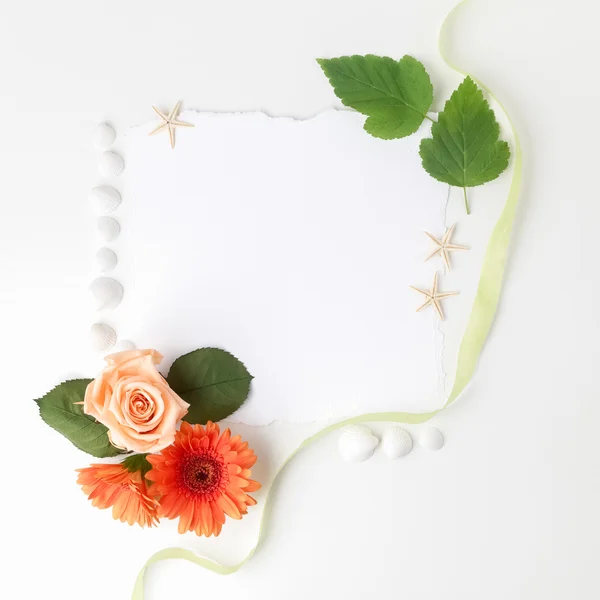 Frame of flowers on a white table ,with space for text, summer theme. Top view. Flat lay.