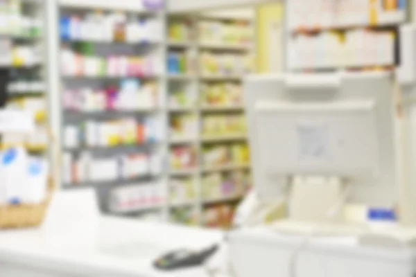 Pharmacy store drugs shelves interior blurred background