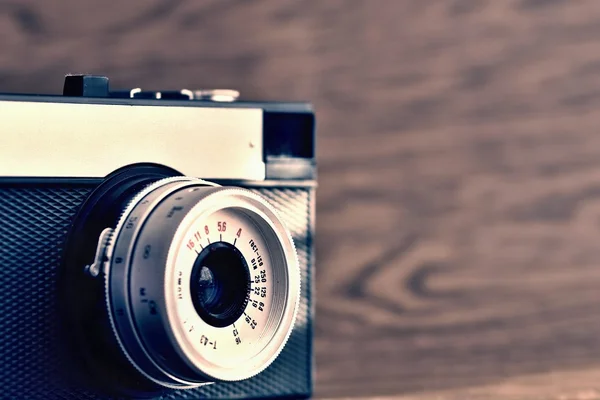 Russian old analog camera on a wooden background.