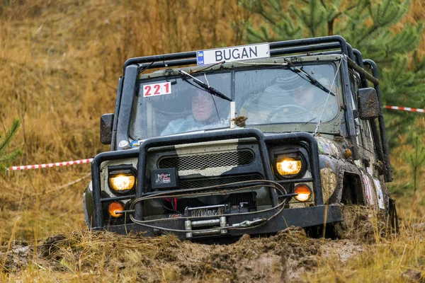 Off-road vehicle brand UAZ overcomes a pit of mud