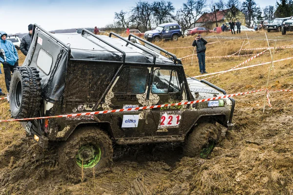 Off-road vehicle brand UAZ overcomes a pit of mud