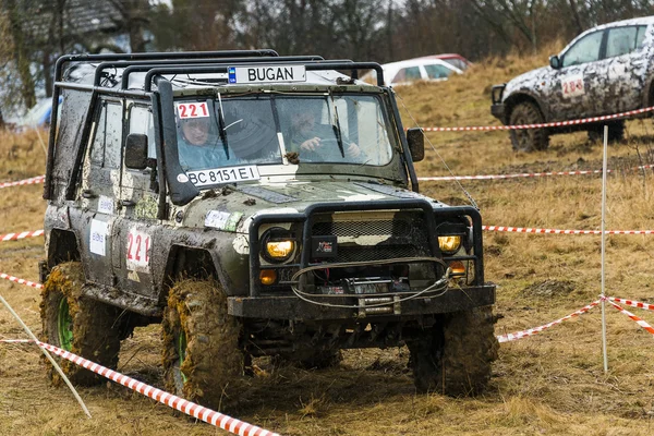 Off-road vehicle brand UAZ overcomes a pit of mud