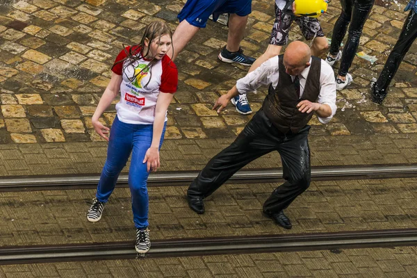Bald man dancing among a people