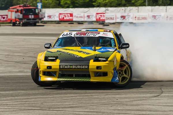 Unknown rider on the car brand Nissan overcomes the track