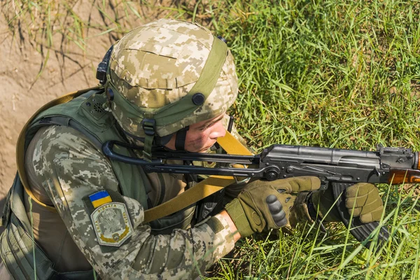 Commando ready to fire from the AK -74 at simulated enemy positi