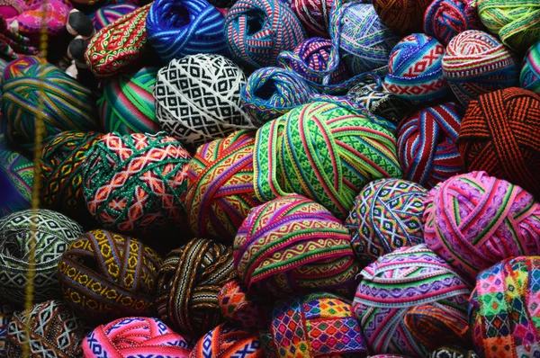 Colorful yarn balls on basket at market