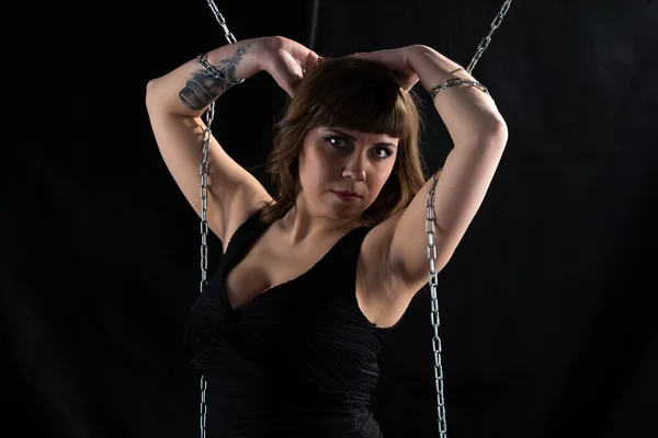 Photo pudgy woman with hands on head, chains