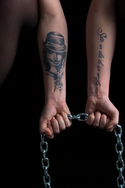 Photo of womans hands holding chain