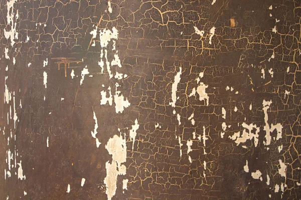 Photo wall with peeling brown paint