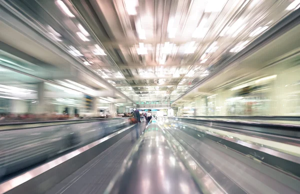 Radial zoom defocused treadmills with motion blur -  Modern international airport - Concept of travel around the world and wanderlust feelings