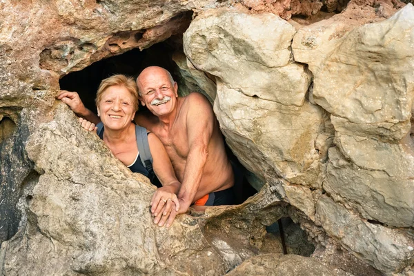 Senior happy couple having fun at the entrance of Kayangan Cave in Coron - Adventure travel in Philippines and asian destinations - Concept of active elderly around the world with no age limitation