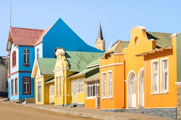 Colorful houses in Luderitz - Architecture concept with ancient german style town in south Namibia - Exclusive travel destination in african european settlement - Warm afternoon color tones