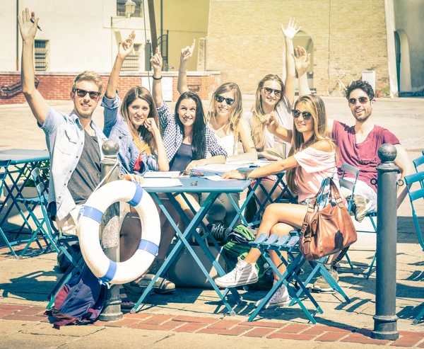 Back to school concept with a group of happy best friends - Tourists having fun in the summer around the old town - University students during a break in a sunny day - Vintage filtered look
