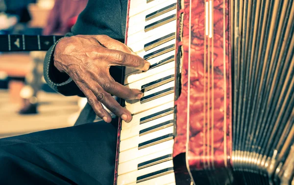 African musician hand playing fisarmonica - Street artist performing traditional songs with accordion