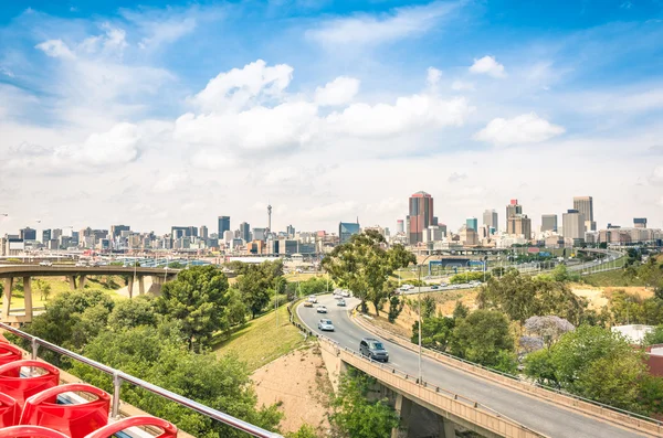 Wide angle view of Johannesburg skyline from the highways during a sightseeing tour around the urban area - Metropolitan buildings of the business district in the capital of South Africa